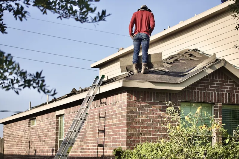 Professional roofer working on a residential roof in Oakwood Overlook